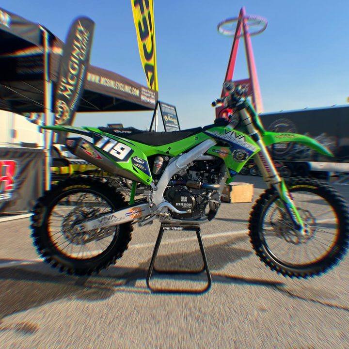 Green Kawasaki race bike in the pits